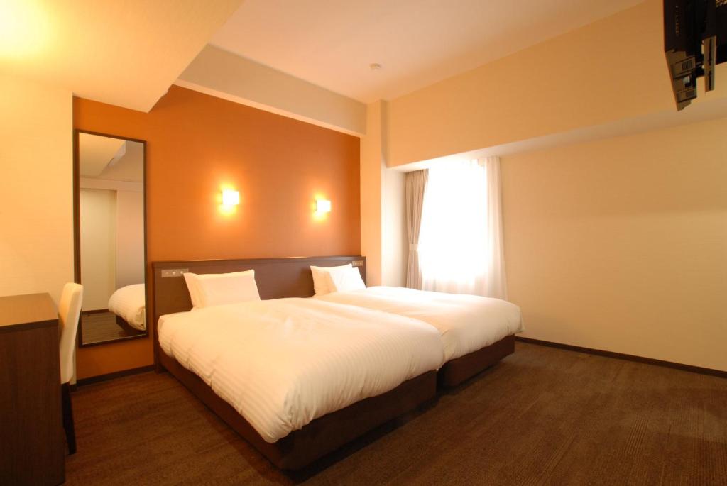 Postel nebo postele na pokoji v ubytování AB Hotel Nara