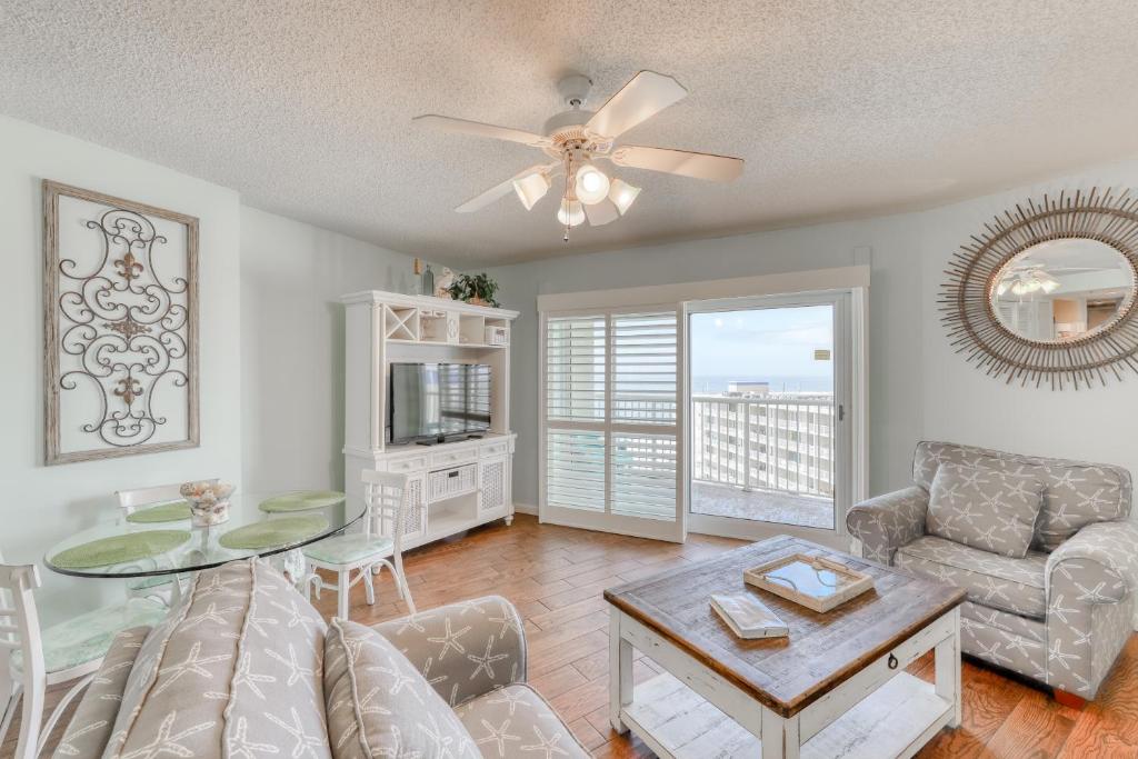 a living room with a couch and a table at Tradewinds #1008 in Orange Beach