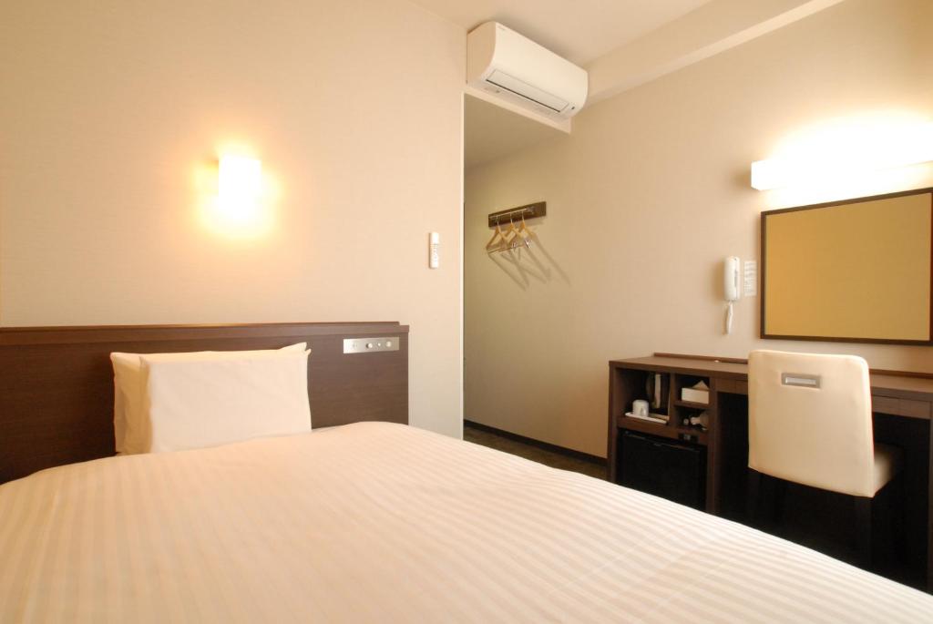 Postel nebo postele na pokoji v ubytování AB Hotel Gifu