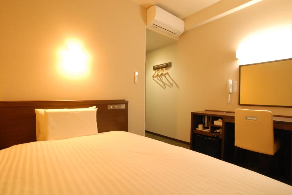 Postel nebo postele na pokoji v ubytování AB Hotel Gifu