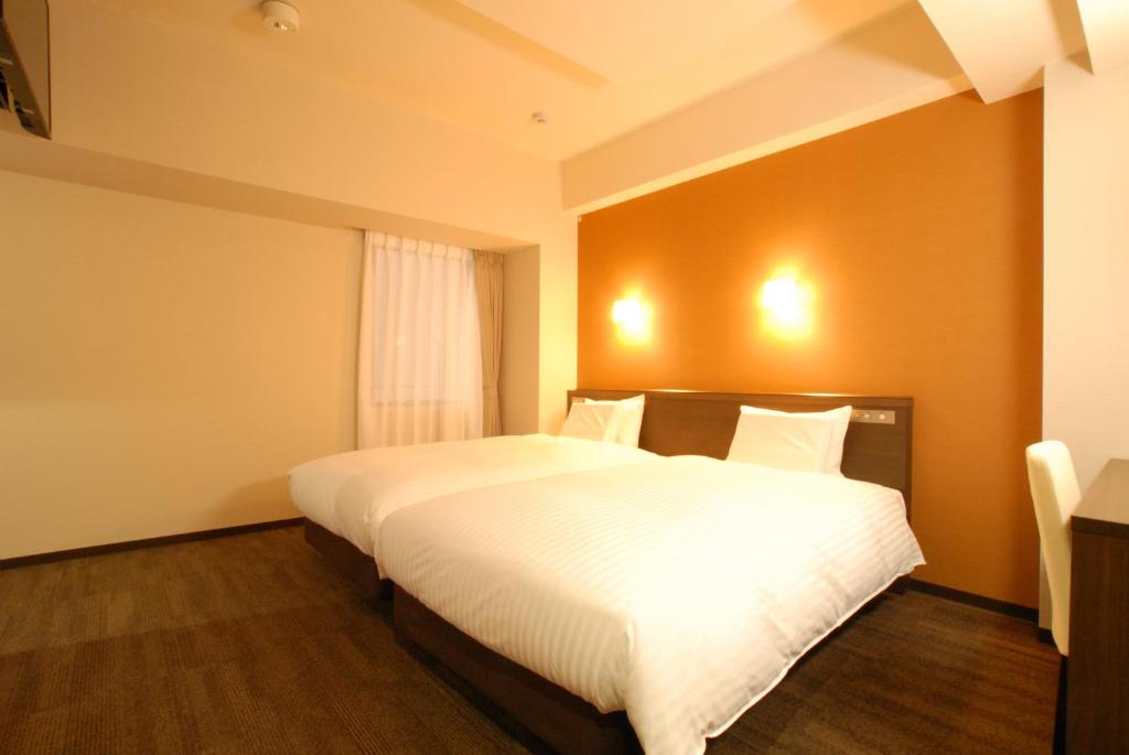 Postel nebo postele na pokoji v ubytování AB Hotel Gifu