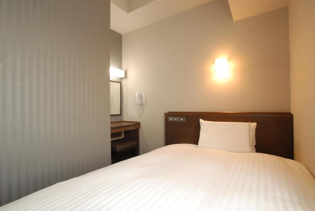 Postel nebo postele na pokoji v ubytování AB Hotel Gifu