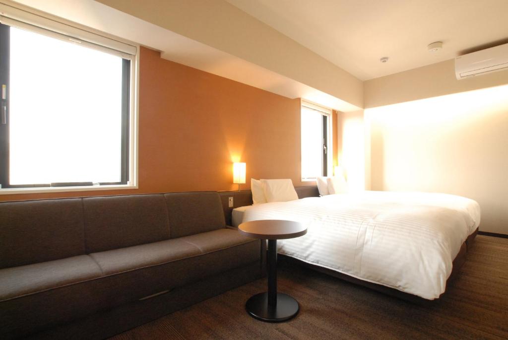 Postel nebo postele na pokoji v ubytování AB Hotel Gifu