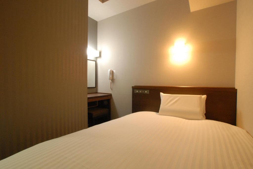 Postel nebo postele na pokoji v ubytování AB Hotel Gifu