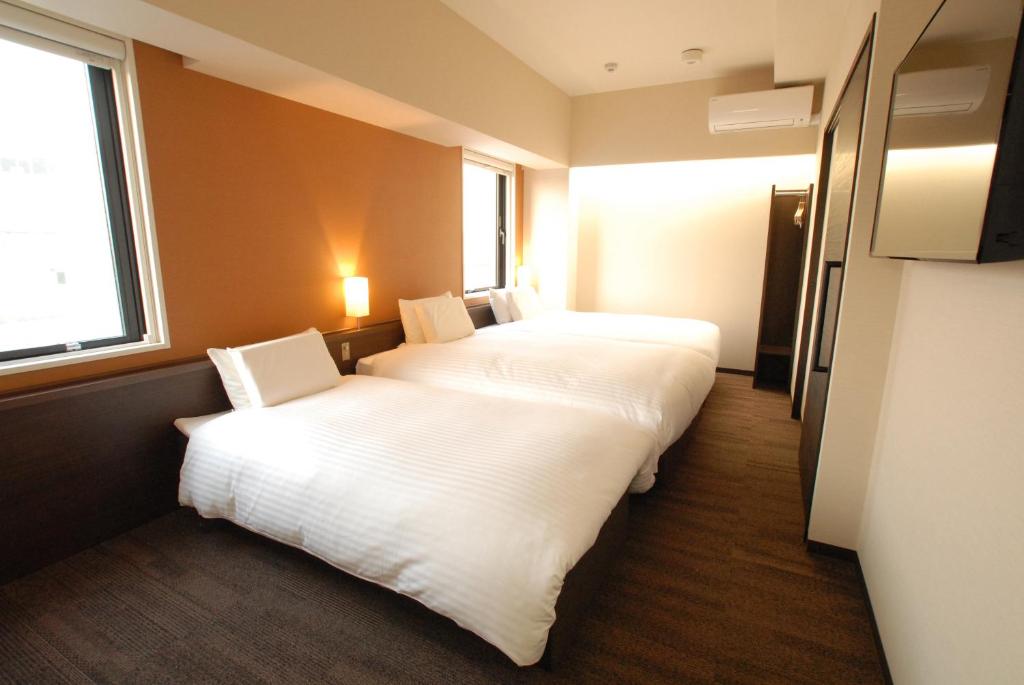Postel nebo postele na pokoji v ubytování AB Hotel Gifu