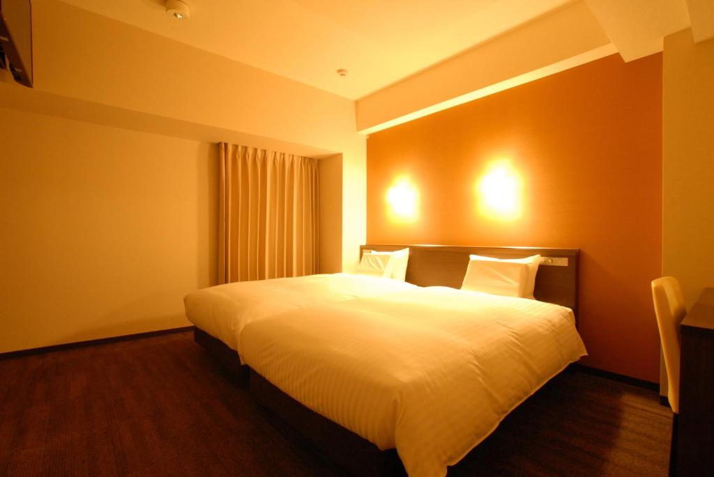 Postel nebo postele na pokoji v ubytování AB Hotel Gifu
