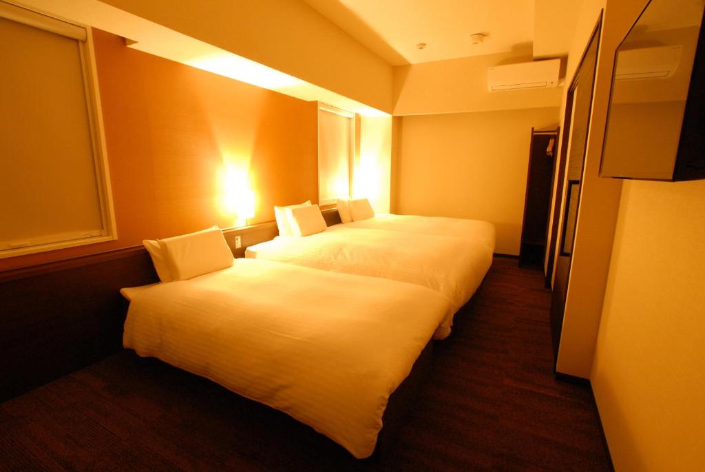 Postel nebo postele na pokoji v ubytování AB Hotel Gifu