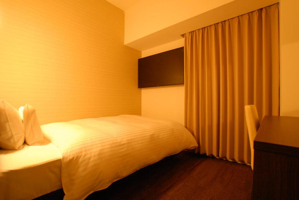 Postel nebo postele na pokoji v ubytování AB Hotel Iwata