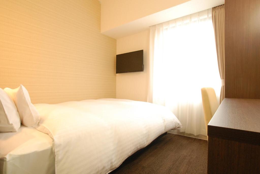 Postel nebo postele na pokoji v ubytování AB Hotel Iwata