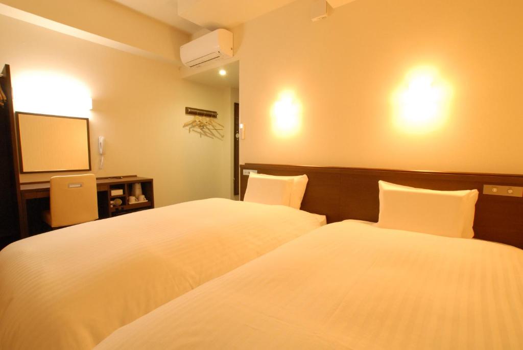 Postel nebo postele na pokoji v ubytování AB Hotel Iwata