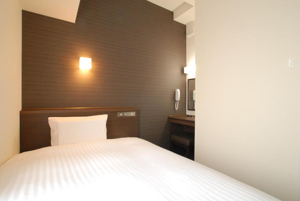 Postel nebo postele na pokoji v ubytování AB Hotel Iwata