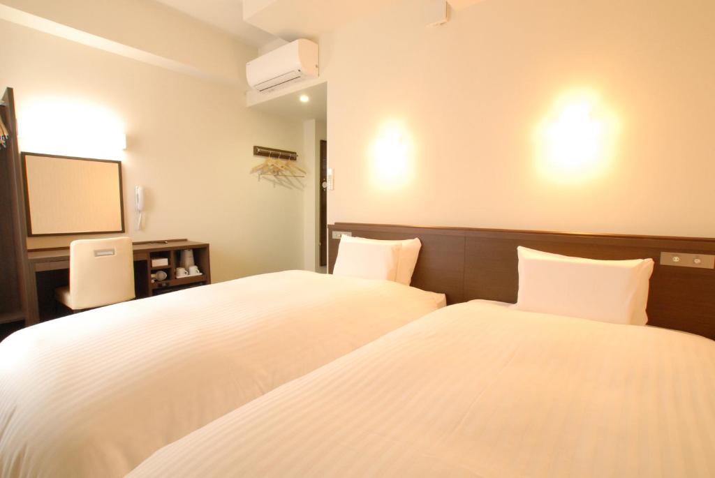 Postel nebo postele na pokoji v ubytování AB Hotel Iwata
