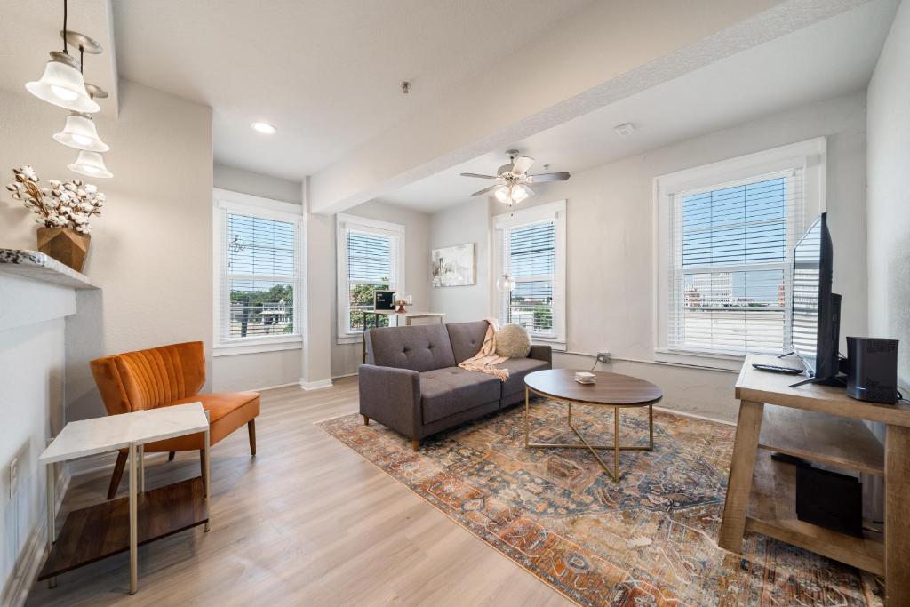 a living room with a couch and a table at Stunning Waco Downtown Apartments in Waco