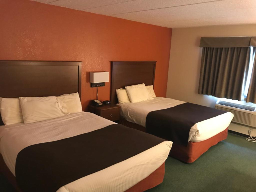 a hotel room with two beds and a window at AmericInn by Wyndham Blackduck in Blackduck