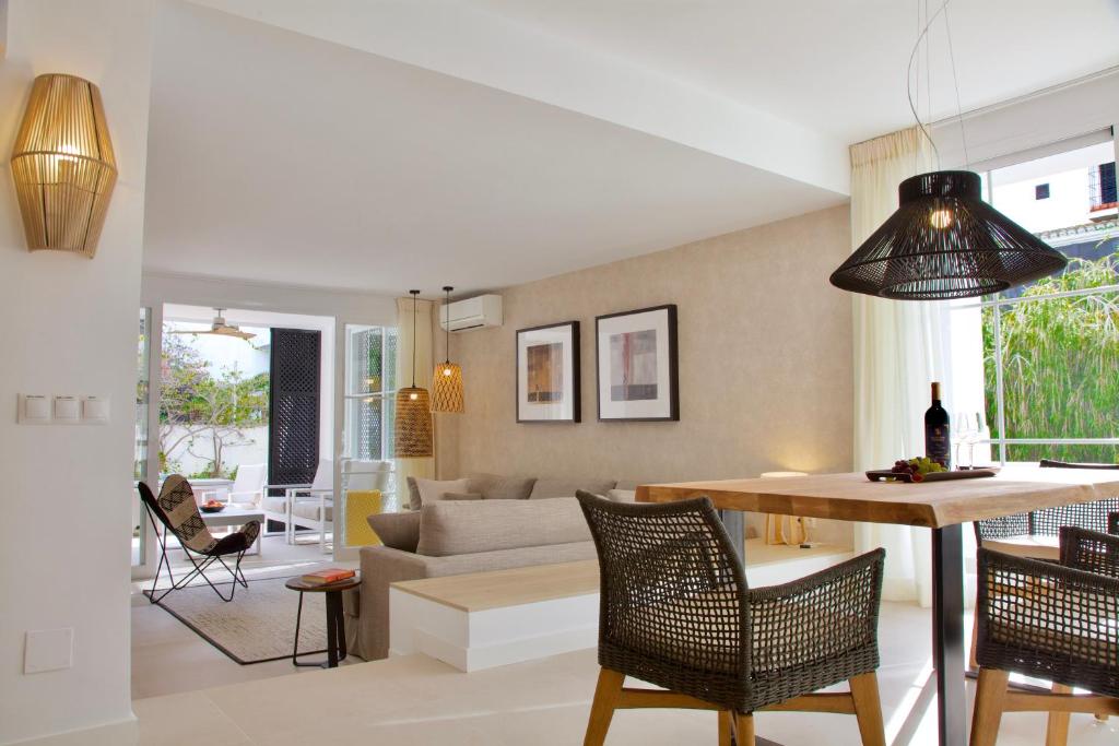 a living room with a couch and a table at Top Apartment in Los Jardines de las Golondrinas in Marbella