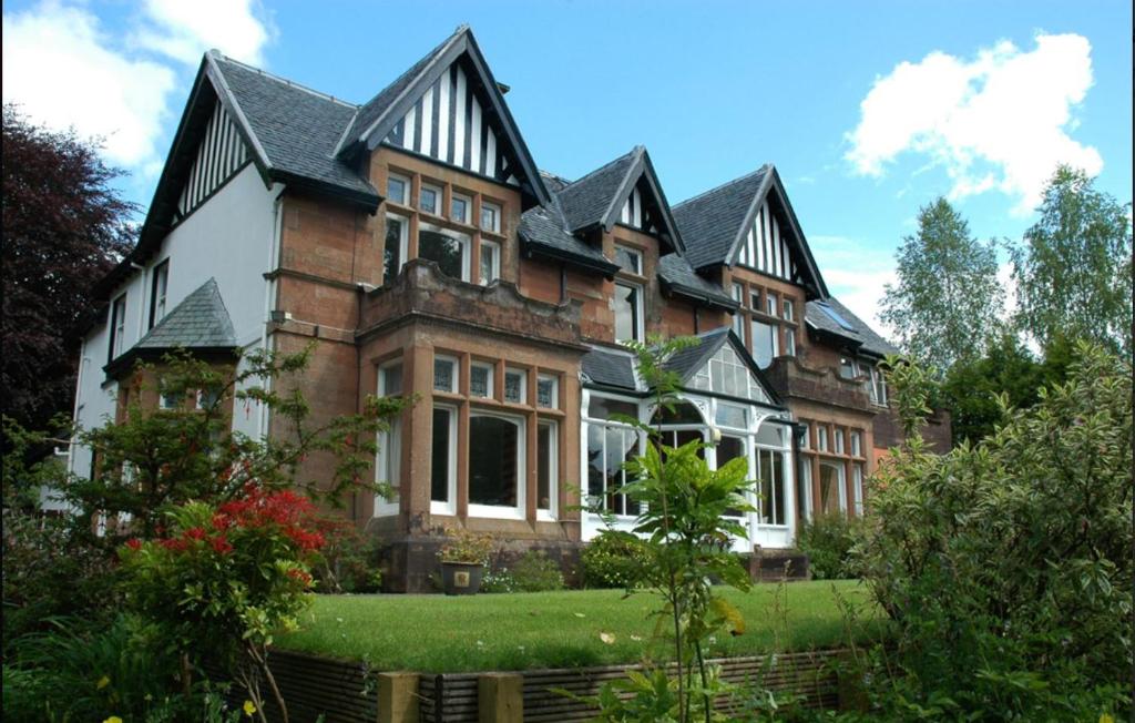 a large brick house with a roof at Ravenswood House B&B in Fort William