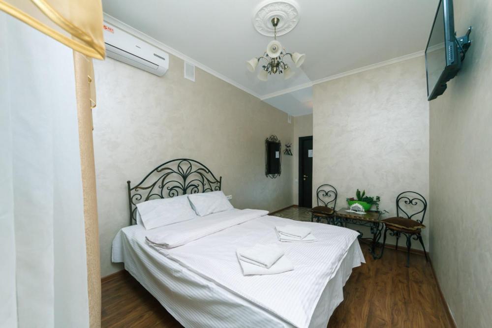 sypialnia z dużym białym łóżkiem w pokoju w obiekcie Mango w Kijowie