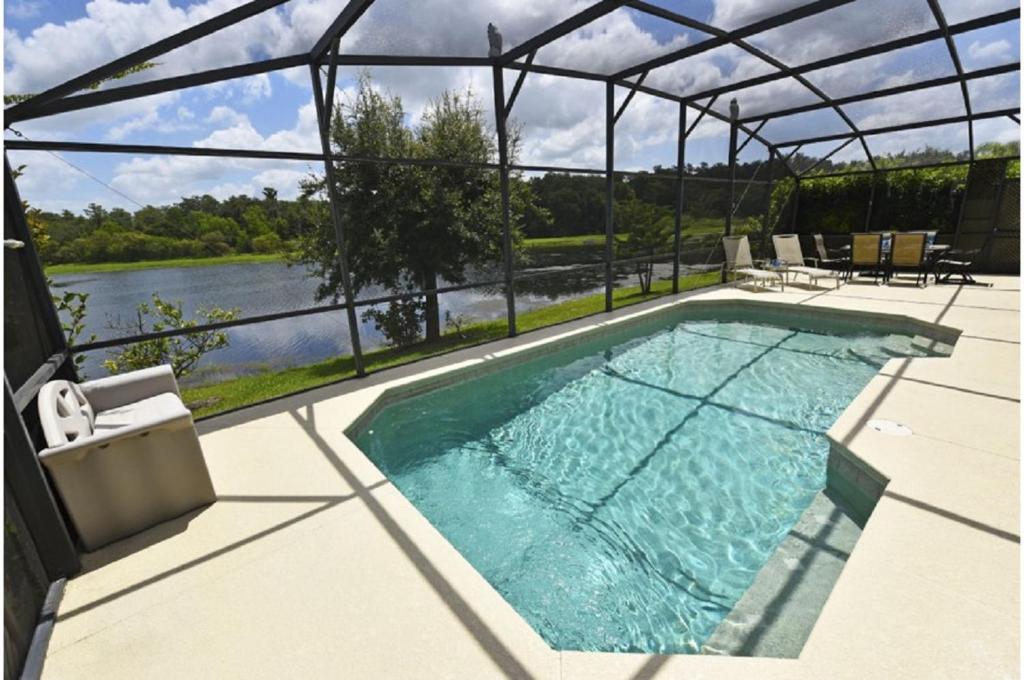 a swimming pool on a patio with a view of a river at Holiday Villas of Davenport in Davenport