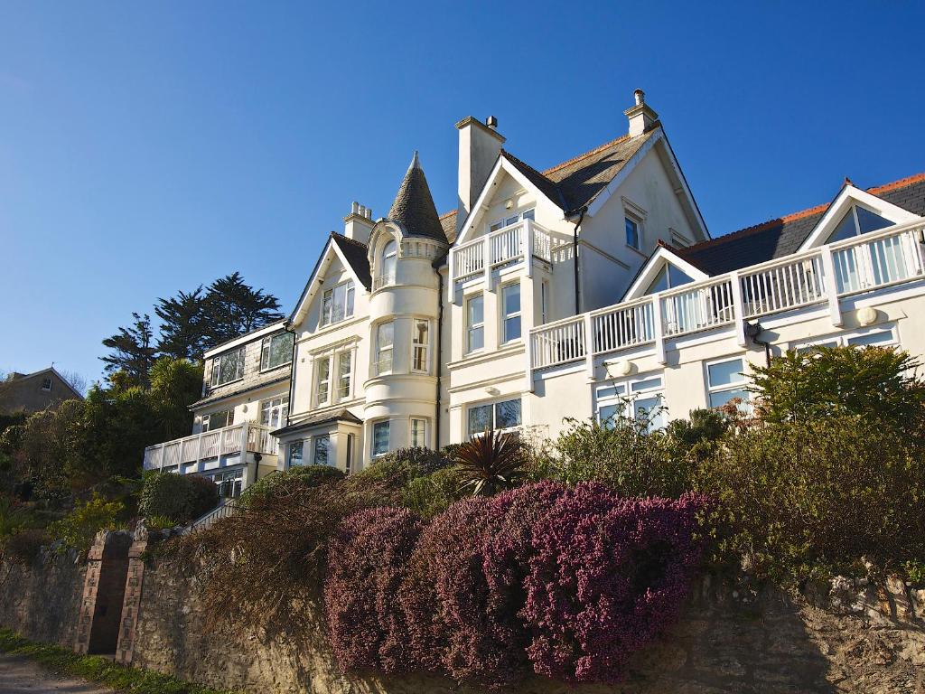 a large white house on top of a hill at 6 Grafton Towers in Salcombe