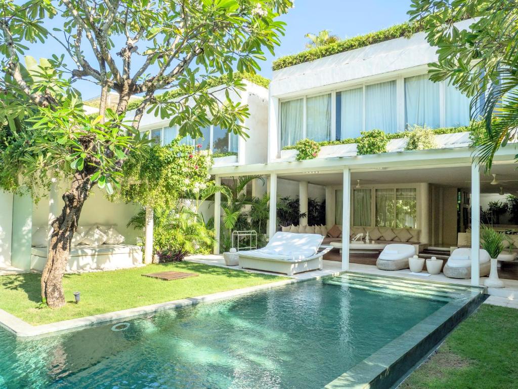 an exterior view of a house with a swimming pool at Eden The Residence at The Sea Seminyak in Seminyak