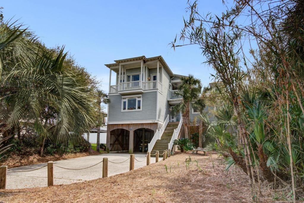 a house on a hill with palm trees at Charisma By The Sea in Folly Beach