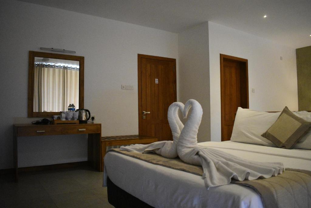 Postel nebo postele na pokoji v ubytování Lotus Lake Residence