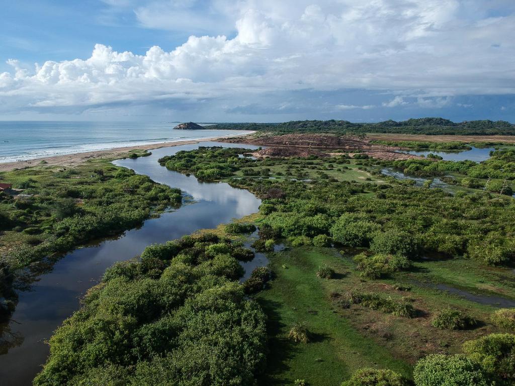an aerial view of a river next to a beach at Kudakalliya Beach House in Arugam Bay