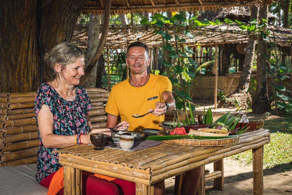 a man and a woman sitting at a table at Eskala Hotels and Resorts in Ngwesaung