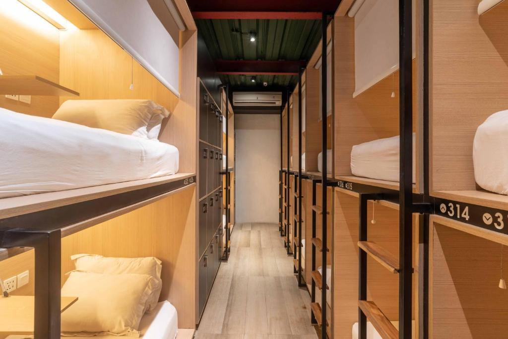 a hallway of a dorm room with bunk beds at M Boutique Hostel Legian in Legian
