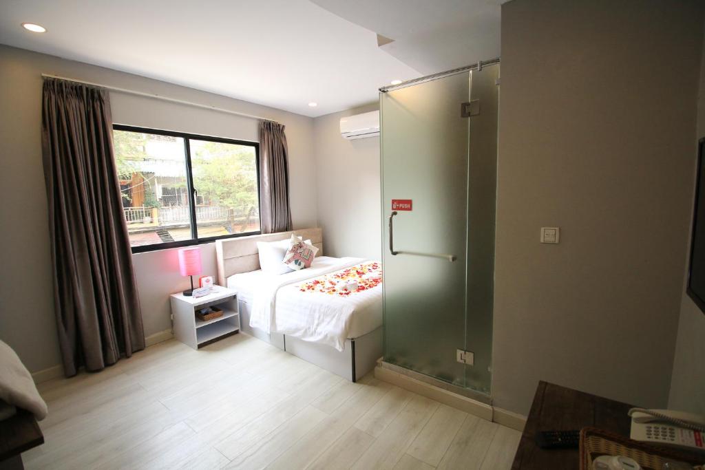 Postel nebo postele na pokoji v ubytování Ostro Hotel