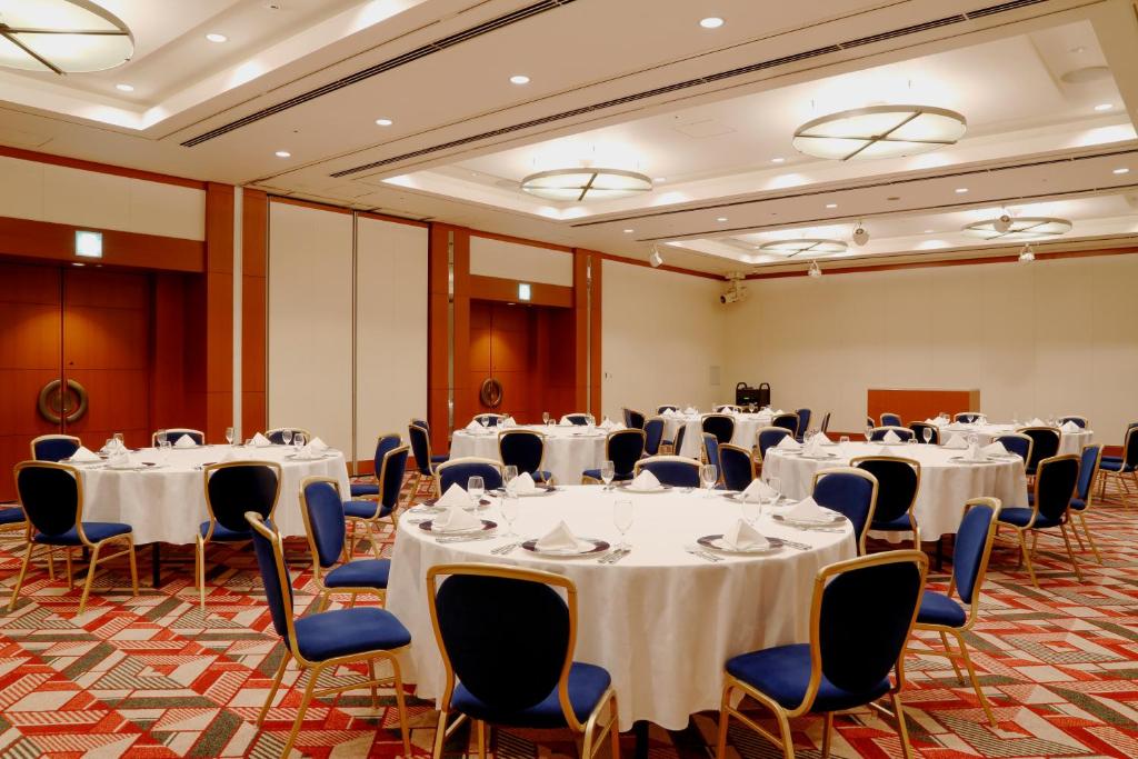 a conference room with white tables and chairs at Hotel Keihan Universal Tower in Osaka