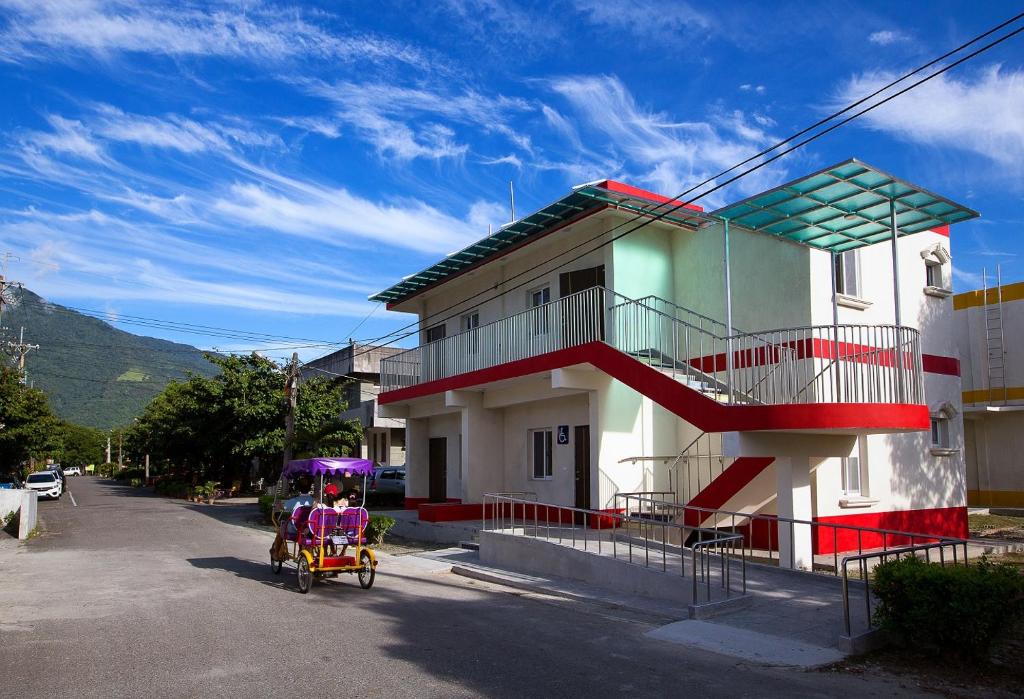 a person in a rickshaw in front of a building at Chinshang Pastoral Farm Resort in Chishang