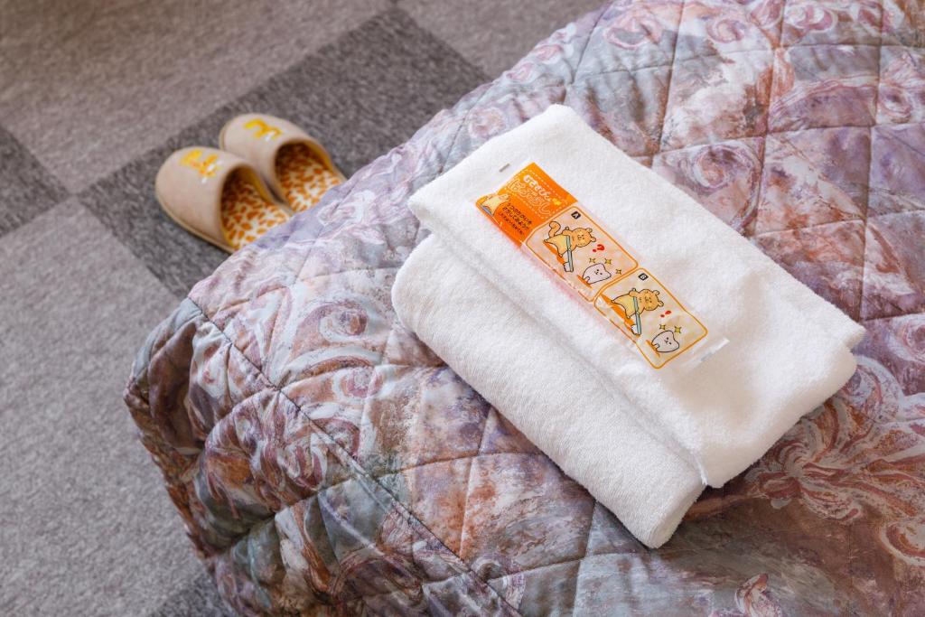 Postel nebo postele na pokoji v ubytování Fukuno Town Hotel A・Mieux