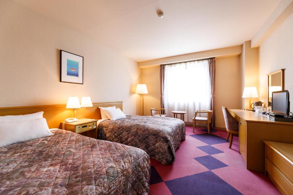 Postel nebo postele na pokoji v ubytování Fukuno Town Hotel A・Mieux