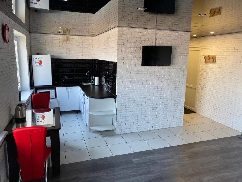 a kitchen with white appliances and a black counter top at Квартира с WiFi и видом на город и р Днепр in Kamianske