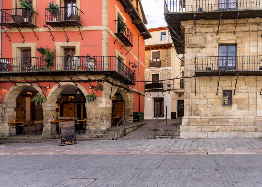 a group of buildings with balconies on a street at Housingleón - Albergue Turístico Nama Hostel in León