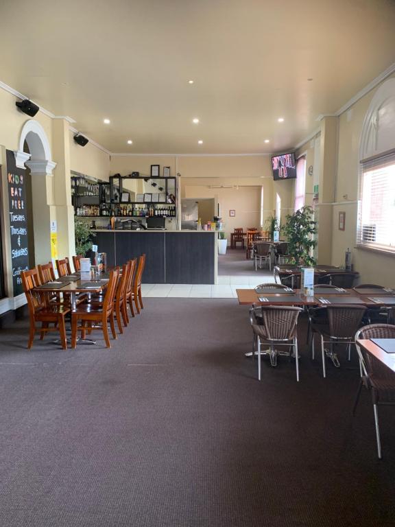 a dining room with tables and chairs in a restaurant at Riverside Hotel in Northam