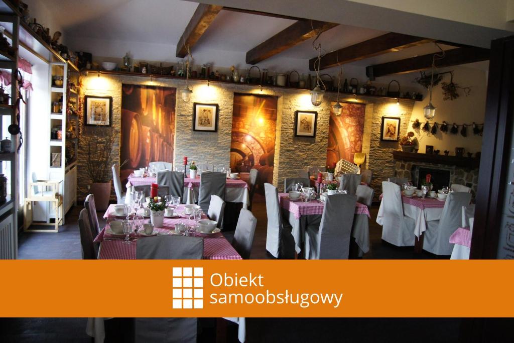 una sala da pranzo con tavoli e sedie in un ristorante di Biały Bór Rooms a Grudziądz