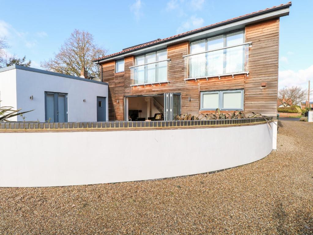 a house with a fence in front of it at Tenison House in North Walsham