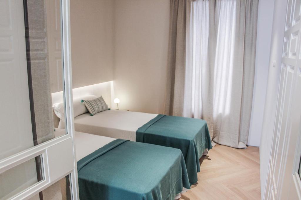 A bed or beds in a room at The Boc Suites