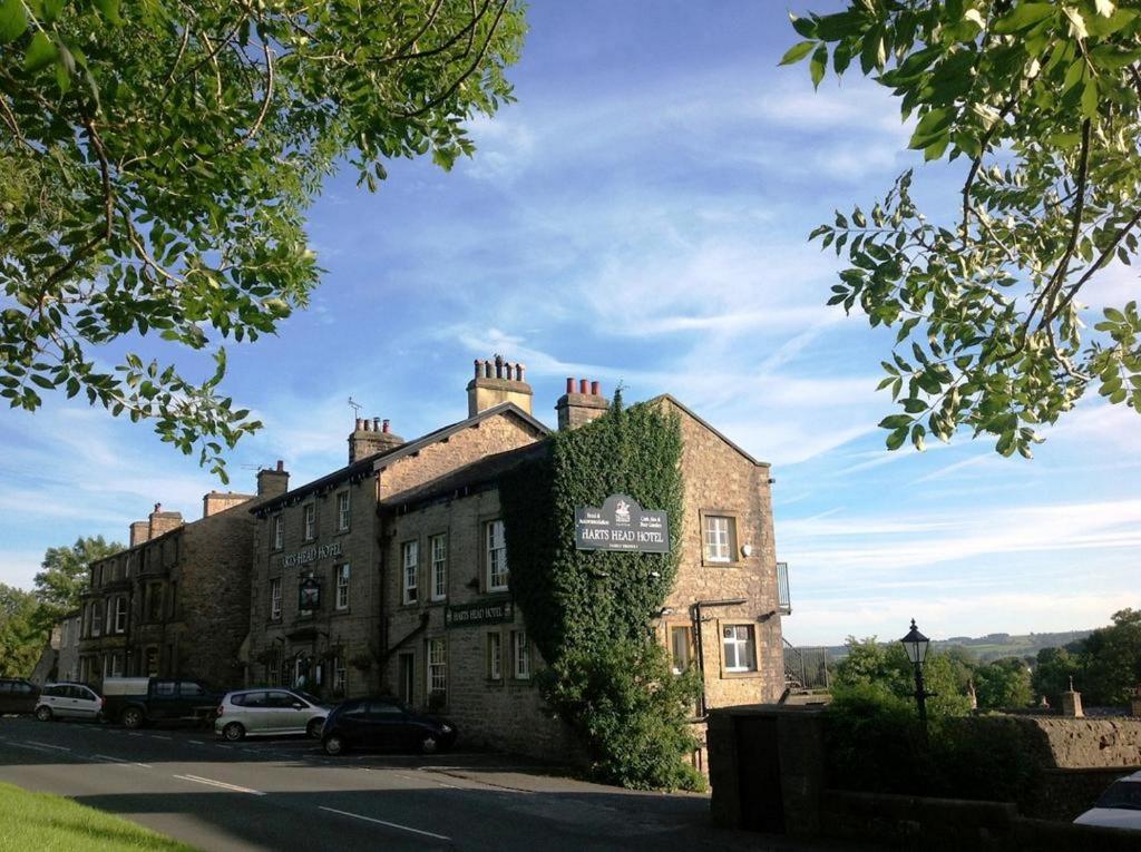 a building with ivy on the side of it at Harts Head Hotel in Settle