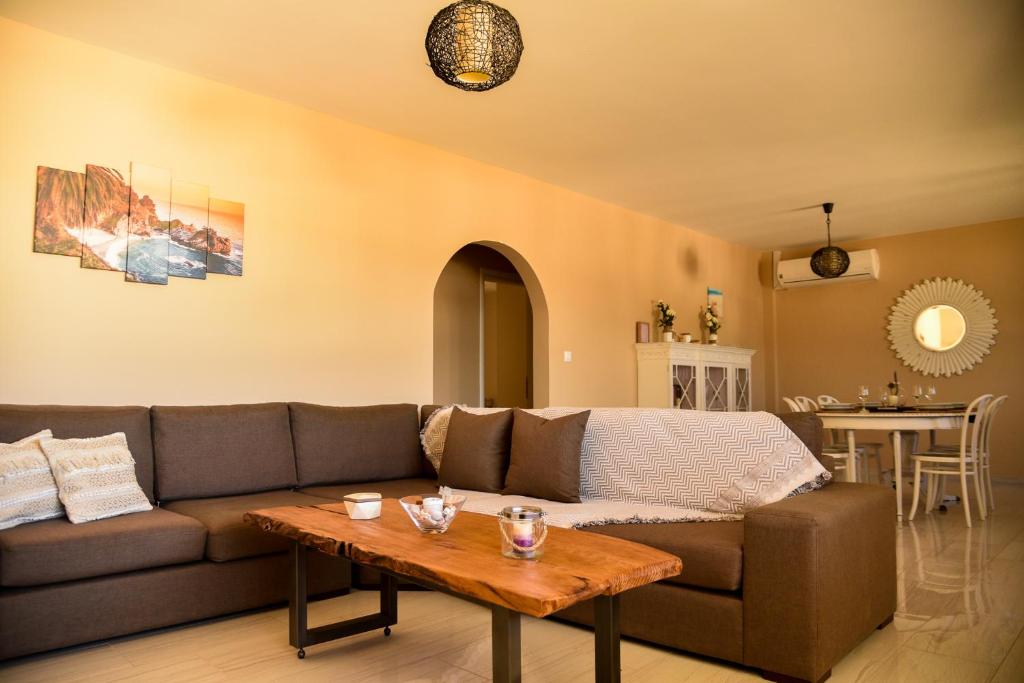 a living room with a couch and a table at Elegant Apartment in Karpathos