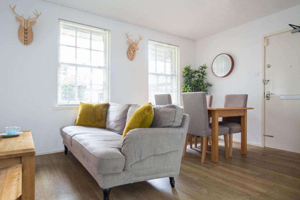 a living room with a couch and a table at Modern Grassmarket Apartment in Edinburgh