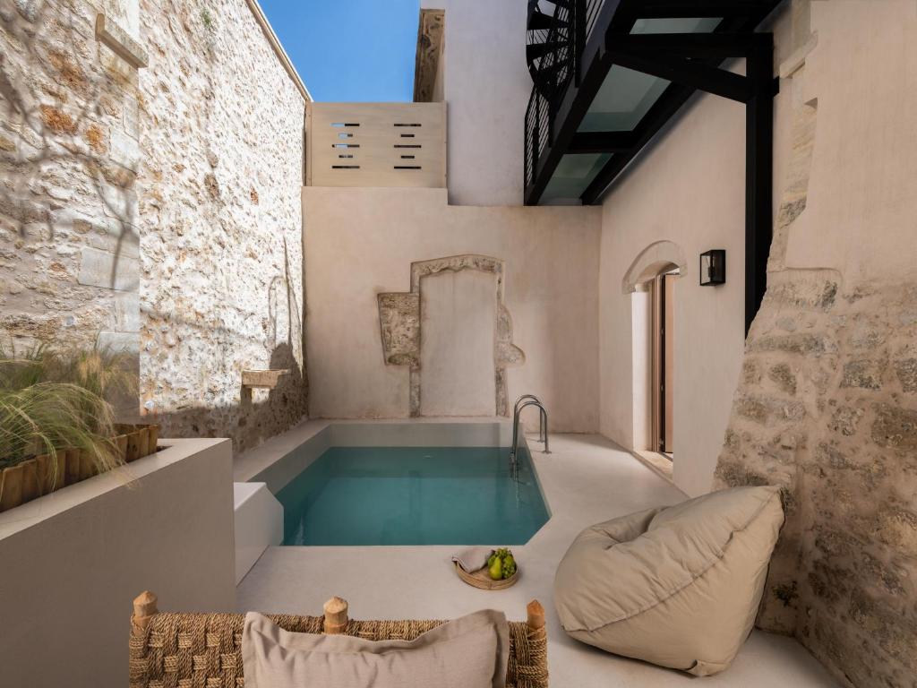 a swimming pool in a house with a tub at Sutor Chic Manor hotel in Rethymno