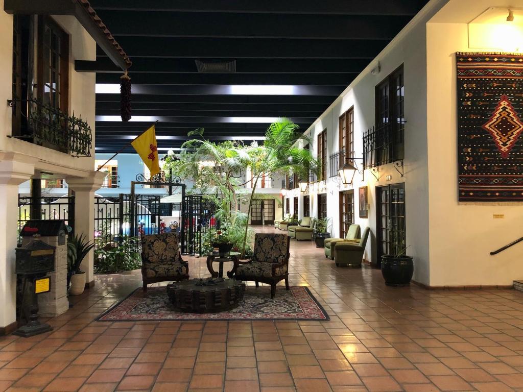 a hallway with chairs and a table in a building at Ramada by Wyndham Las Cruces Hotel & Conference Center in Las Cruces