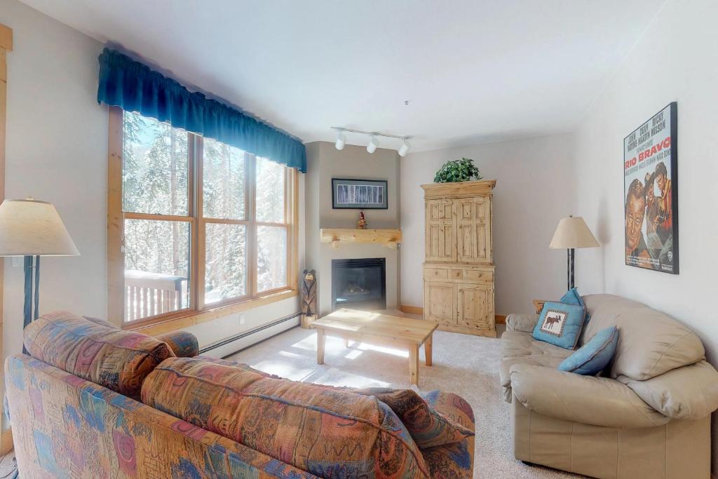 a living room with a couch and a fireplace at Trappers Crossing 8763 in Keystone