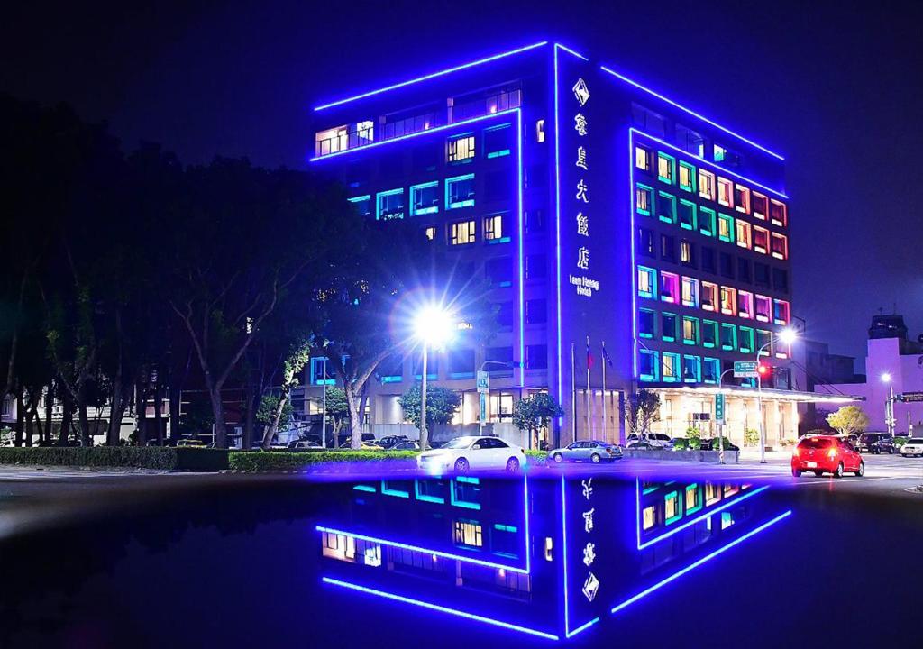 a building with blue lights in a city at night at Tsun Huang Hotel in Chiayi City