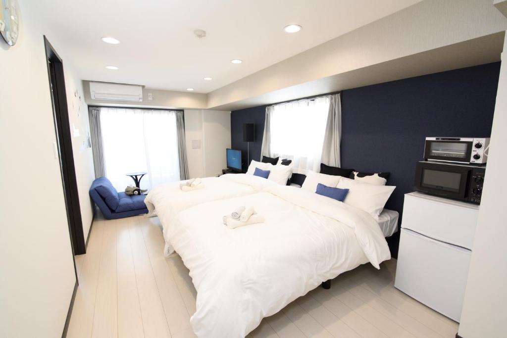Postel nebo postele na pokoji v ubytování Hotel Central Yokohama