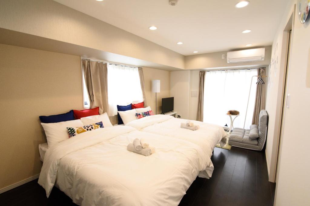 Postel nebo postele na pokoji v ubytování Hotel Central Yokohama