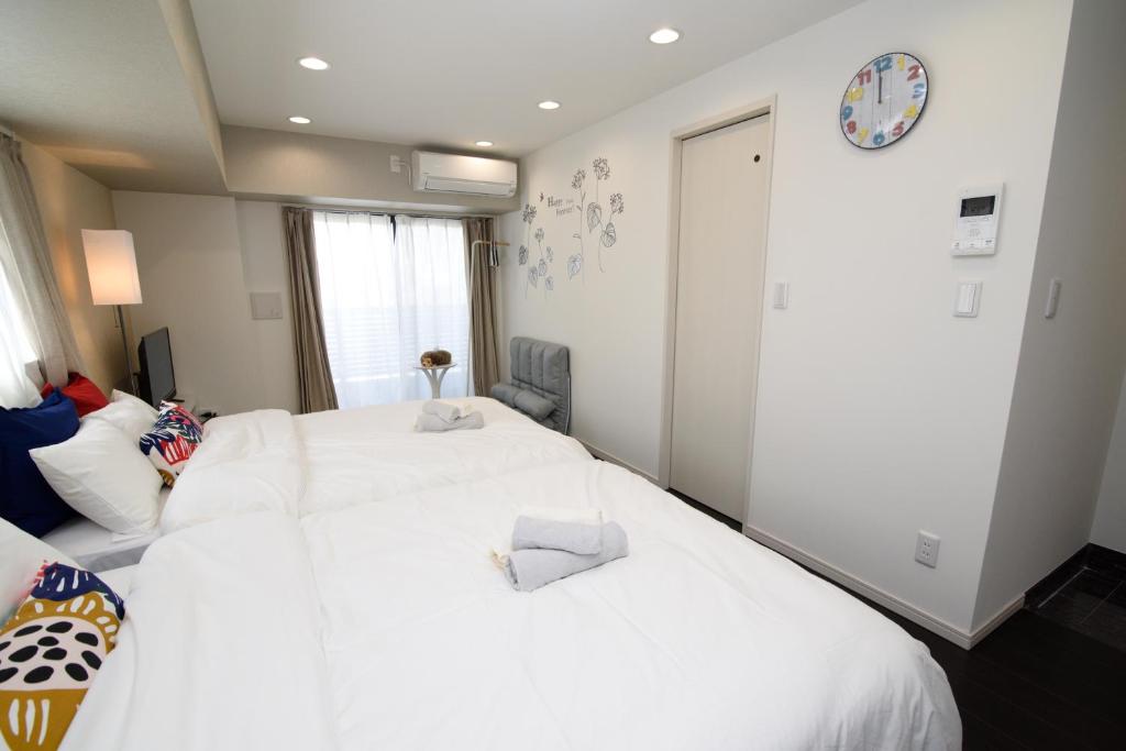 Postel nebo postele na pokoji v ubytování Hotel Central Yokohama